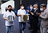Samsung Electronics employees carry wafers manufactured with 3-nanometer technology on July 25 during a shipping ceremony for the products at the chipmaker's plant in Hwaseong, Gyeonggi. Samsung Electronics became the world's first company to mass produce 3-nanometer chips. [YONHAP]