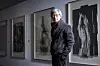 Renowned photographer Koo Bohnchang stands before his works now on view at Seoul Museum of Art (SeMA) in central Seoul. [CHOI YEONG-JAE]