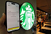 A model demonstrates Apple Pay at a Starbucks store in Seoul on May 8. [NEWS1]