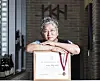 Architect Hong Tae-sun poses with his Fellow of the American Institute of Architects certification at the YKH Associates Headquarters in Gangnam District, southern Seoul, on June 17. [JOONGANG ILBO]
