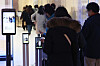 People scan QR codes for entry into a shopping mall in Seoul on Sunday. Starting Monday, vaccine passes will be required at large discount supermarkets and department stores. [YONHAP]