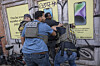 A street raid by Immigration and Customs Enforcement agents and other federal law enforcement officers along Canal Street in New York, Oct. 21, 2025. On Monday, Dec. 8, the developer of the ICEBlock app, Joshua Aaron, sued top Trump administration officials, accusing them of pressuring Apple to stifle his free speech and his right to create, distribute and promote the app that allowed users to alert people when they saw ICE agents. (Victor J. Blue/The New York Times)