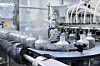 Transparent bottles of Hwayo soju move along the automated bottling line at the company’s plant in Yeoju. [HWAYO]