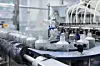 Transparent bottles of Hwayo soju move along the automated bottling line at the company’s plant in Yeoju. [HWAYO]