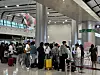 Travelers wait for their flight on the third floor at Jeju International Airport on Friday. [JOONGANG ILBO]