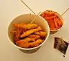 Smelt fries, fresh out of the fryer next to the fishing booth is a winter treat favored among Koreans attending winter festivals. [KIM DONG-EUN]