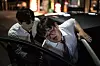 A person who seems to be in a junior position takes care of his senior, who appears to be quite drunk. [GETTY IMAGES BANK]