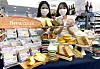 Models pose with various breads from Brea;daum, a bakery brand from 7-Eleven. [7-ELEVEN]