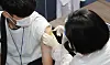 A 12th grad student gets a Covid-19 vaccine at an inoculation center in Busan, July 19. [SONG BONG-GEUN]