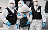 The Chinese infected with Covid-19 that bolted after arriving in Korea escorted to a hotel in Incheon, on Thursday. [YONHAP]