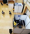A Gwangmyeong city government employee sanitizes a booth where job seekers were interviewed by video at the city hall in Gyeonggi Tuesday. Because of the coronavirus pandemic, job interviews are mostly conducted in ways that do not require in-person meetings. [YONHAP]