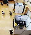 A Gwangmyeong city government employee sanitizes a booth where job seekers were interviewed by video at the city hall in Gyeonggi Tuesday. Because of the coronavirus pandemic, job interviews are mostly conducted in ways that do not require in-person meetings. [YONHAP]