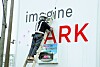 A worker erases the word ″Ipark″ from a hoarding on a construction site on Feb. 1. Ipark is the apartment brand of Hyundai Development Company, and people have been reluctant to move into its apartments after a HDC-built building collapsed in January. [YONHAP]