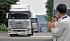 Workers at Hyundai Motor's Jeonju plant in North Jeolla celebrate as the world's first mass-produced hydrogen-powered commercial vehicles, Xcient Fuel Cells, leave to be shipped to Switzerland. [HYUNDAI MOTOR]