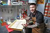 Jun Gi-hong, owner-chef of The Slice Pizza, poses with pizza dough in the kitchen of The Slice Pizza [PARK SANG-MOON]