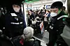 Members of the Solidarity Against Disability Discrimination board a subway train at Samgakji Station in central Seoul on Tuesday as part of a protest demanding more spending on people with disabilities. [YONHAP]