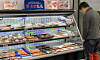 A customer looks at salmon displayed at a supermarket in Seoul on Sunday. The price of salmon fillets at retail markets increased between 15 to 26 percent last week compared to the beginning of the month, according to industry insiders. The price of Norwegian salmon has been rising due to the Russian invasion of Ukraine, as the Norwegian fish products used to be imported through Russia but now must be shipped on a longer route, topped with rising oil prices around the world. [YONHAP]