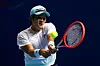 Kwon Soon-woo plays a backhand in his men's singles first round match against Thai-Son Kwiatkowski of the United States at the Singapore Tennis Open on Wednesday in Singapore. [GETTY IMAGES]