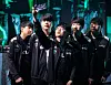 Members of the DWG KIA League of Legends team take a group selfie on the stage of the 2021 Mid-Season Invitational. [RIOT GAMES]