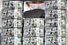 An employee poses with stacks of dollar bills at a Hana Bank branch in Jung District, central Seoul, on Wednesday. According to data from the Bank of Korea, foreign exchange reserves came to $420.55 billion as of the end of September, up $1.59 billion from a month earlier. [YONHAP]