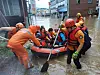 Firefighters rescue people in Gurye County, South Jeolla, on Saturday as the area was flooded by heavy rains. [NEWS1]