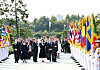 President Yoon Suk Yeol, center, and first lady Kim Keon-hee, second from right, joined by foreign dignitaries, salute the flag as they visit the United Nations Memorial Cemetery in Busan to mark the 70th anniversary of the armistice agreement that ended the 1950-53 Korean War on Thursday.