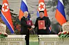In this photo released by Pyongyang's state-controlled Rodong Sinmun in June, Russian President Vladimir Putin, left, shakes hands with North Korean leader Kim Jong-un during their summit in Pyongyang after signing a treaty in which the two countries promised to provide military support to each other if one comes under attack. [NEWS1]
