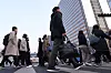 Pedestrians walk on a crosswalk in central Seoul on Feb. 13. [YONHAP]