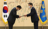 President Moon Jae-in, right, hands an appointment letter to Prime Minister Kim Boo-kyum at a ceremony at the Blue House on Friday.  [YONHAP]