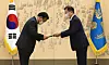 President Moon Jae-in, right, hands an appointment letter to Prime Minister Kim Boo-kyum at a ceremony at the Blue House on Friday. [YONHAP]
