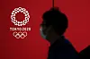 A pedestrian walks past a Tokyo 2020 Olympics logo in Japan Wednesday. Japanese Prime Minister Yoshihide Suga on Tuesday called North Korea's decision to skip the Tokyo Olympics a unilateral announcement. [AFP/YONHAP]
