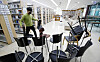A worker at a library in Gwangju removes chairs to guarantee social distancing Wednesday as the city prepares for Level 1.5 social distancing measures. [YONHAP]