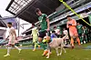 Jeonbuk Hyundai Motors players enter Jeonju World Cup Stadium on Saturday with a dog to promote dog blood donation ahead of a match against Jeju United. The muzzle the dog is wearing is the same kind worn when dogs donate blood. [NEWS1]