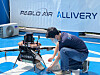 An employee loads the drone with items to be delivered. [LEE TAE-HEE]