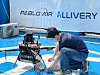An employee loads the drone with items to be delivered. [LEE TAE-HEE]