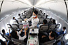 A T’way Air flight attendant handing duty-free purchases to a passenger on a flight to nowhere, that takes off and lands back where it started without an intermediate stop, between Daegu and Fukuoka, Japan. The budget airliner said Sunday that it has started its inflight duty-free shopping for customers getting on from the Daegu International Airport. [YONHAP]