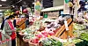 A customer examines vegetables at a Lotte Mart store [LOTTE SHOPPING]