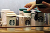 A customer grabs a Starbucks tumbler at a store in Seoul. [NEWS1]