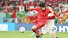 Son Heung-min vies for the ball in injury time without wearing his face mask during Korea's last group stage match against Portugal on Friday evening at the Education City Stadium in Al-Rayyan, west of Doha. Son is holding his protection mask in his hand instead of wearing it on his face. [NEWS1]
