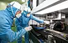 An employee at Samsung Electronics, left, and an employee at Eo Technics look into a semiconductor laser facility jointly developed by the two companies. Samsung Electronics announced Thursday that it will keep on fostering partnerships with local small- and medium-sized enterprises in the semiconductor segment. On top of the cooperation, the tech giant intends to provide consulting for its partners to develop a competitive ecosystem. It has partnered with different chip equipment suppliers in Korea including Eo Technics, SoulBrain and Cinos. [SAMSUNG ELECTRONICS]