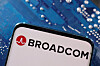 A smartphone with a displayed Broadcom logo is placed on a computer motherboard [REUTERS]