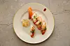 Norwegian salmon sushi topped with spicy buldak mayo and onion mayo sauces, along with a tasting of new farmed cod, is served by Japanese sushi chef Koji Nakamura during a luncheon hosted by the Norwegian Embassy in Seoul on Thursday. [NORWEGIAN SEAFOOD COUNCIL]]
