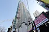 A group of people asking for compensation from HDC Hyundai Development after the collapse of an apartment building in Gwangju stand in front of the site of the collapse on Tuesday. Wednesday is the first anniversary of the collapse, which killed six workers. [YONHAP]