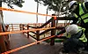 Officials in Gangneung, Gangwon, close off walking trails along Gyeongpo Beach Wednesday as the city prepares to block access to all its major tourist destinations to prevent possible transmission of the coronavirus. [YONHAP]