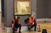Climate protesters of Last Generation after throwing mashed potatoes at the Claude Monet painting ″Les Meules” at Potsdam’s Barberini Museum on Sunday Oct. 24, 2022, to protest fossil fuel extraction. (Last Generation via AP)