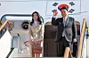 President Yoon Suk Yeol, right, accompanied by first lady Kim Keon Hee, waves before boarding the presidential plane to head to Riyadh, Saudi Arabia, for a six-day trip which will also take him to Qatar from the Seoul Air Base in Seongnam, Gyeonggi, Saturday. [PRESIDENTIAL OFFICE]