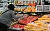 An employee at a discount mart in Seoul arranges fruits on a shelf on Wednesday. [NEWS1]
