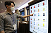 An employee demonstrates a digital vending machine during an invention event organized by the Korean Intellectual Property Office and the Korea Invention Promotion Association at the 63 Convention Center in Seoul on Monday. [NEWS1]