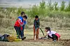A group of children in Mongolia take part in planting trees in 2017 after a session with Korean experts. [KOREA FOREST SERVICE]