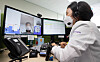 A medical worker talks to a coronavirus-infected patient via video link at Seongnam Citizens Medical Center in Seongnam, Gyeonggi, on Friday. The patient is being treated at home with Paxlovid, Covid-19 treatment pills developed by U.S. pharmaceutical giant Pfizer. [YONHAP]